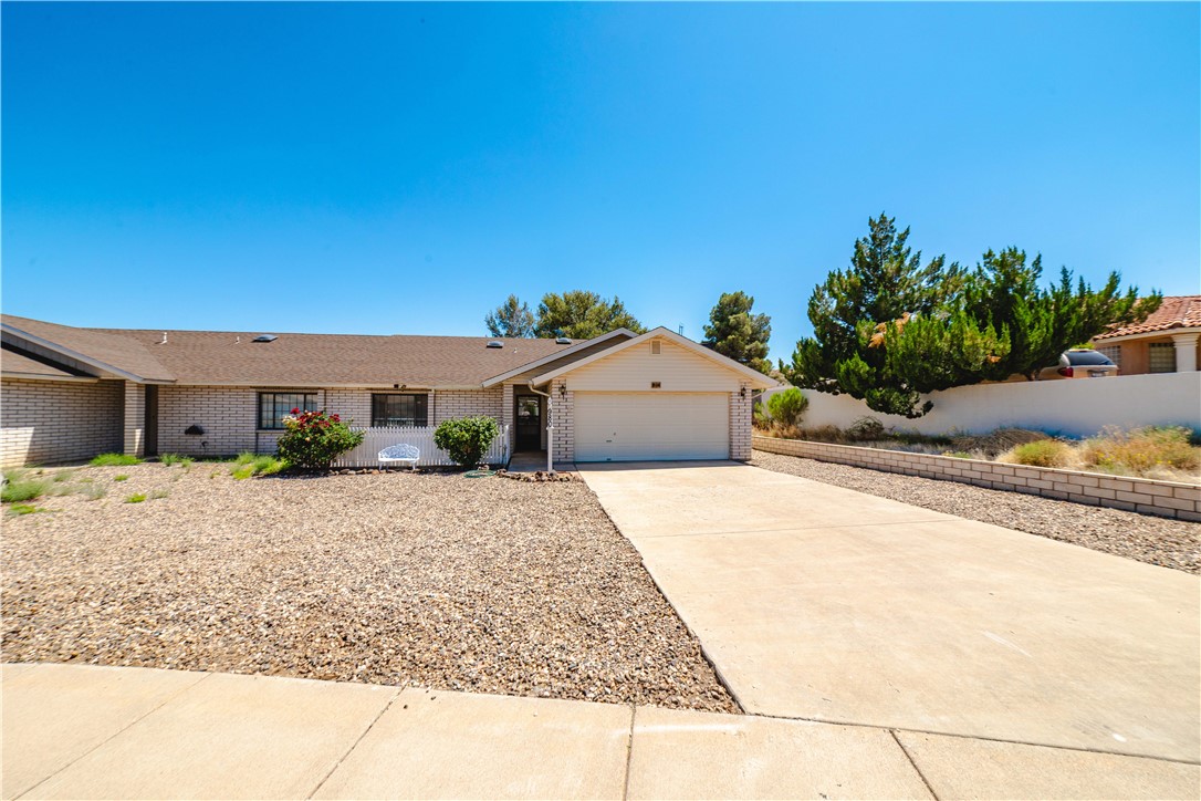 980 Canyon Hills Road Kingman, AZ 86409 - Photo 7 of 42 a front view of a house with a yard and garage