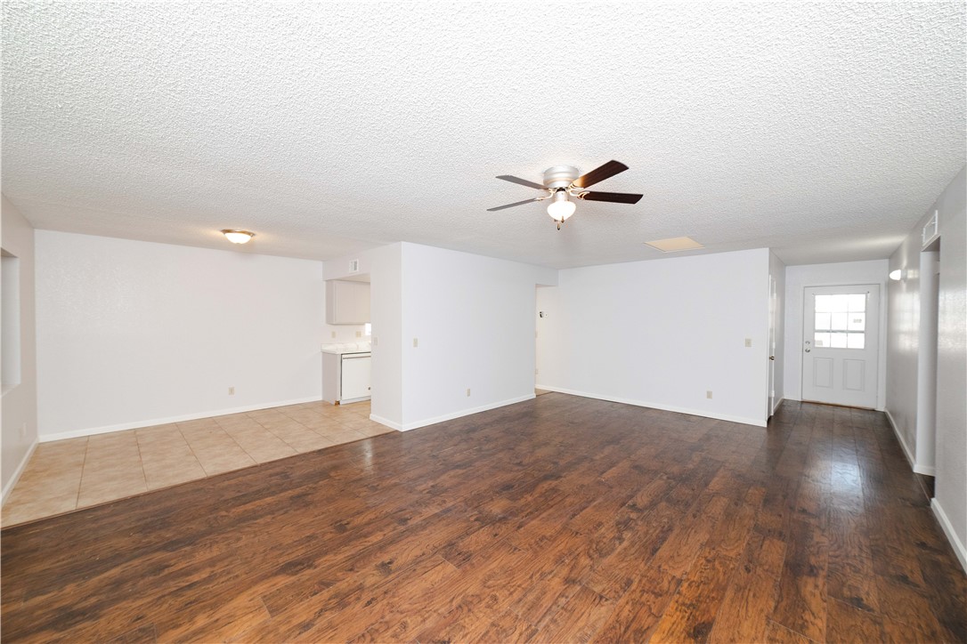 980 Canyon Hills Road Kingman, AZ 86409 - Photo 8 of 42 a view of an empty room with wooden floor and a ceiling fan