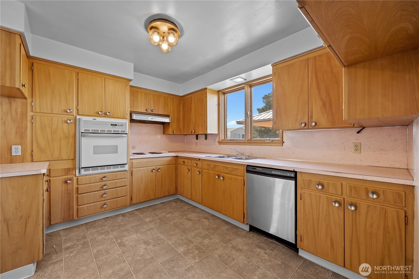 1278 North Paha Packard Road Ritzville, WA 99169 - Photo 7 of 37 a kitchen with cabinets stainless steel appliances a window and a sink