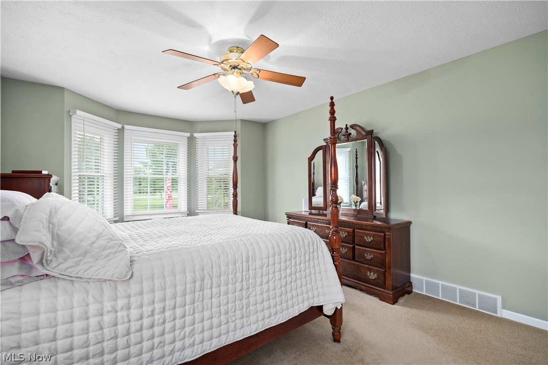 3270 North Ridge Road Vermilion, OH 44089 - Photo 30 of 49 Bay window with multiple panels, ceiling fan with integrated lighting, and neutral wall tones