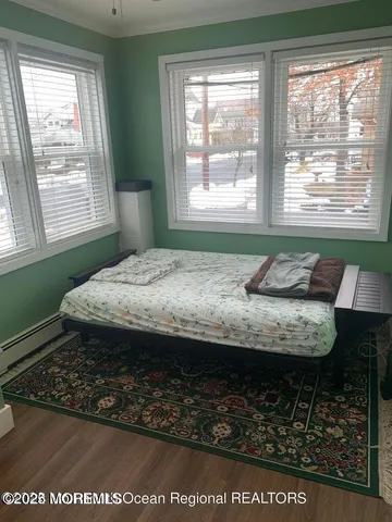 a bed sitting in a bedroom next to a window
