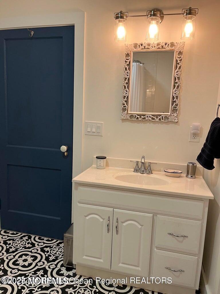 140 Franklin Avenue, Unit FRONT Ocean Grove, NJ 07756 - Photo 6 of 6 a bathroom with a sink and a mirror