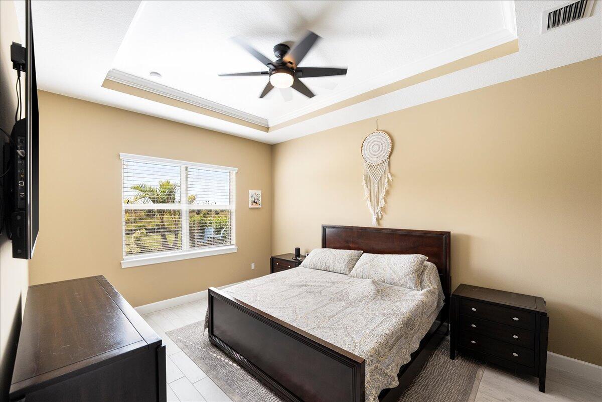 9941 Southwest Legacy Drive Stuart, FL 34997 - Photo 11 of 33 a bedroom with a bed and window