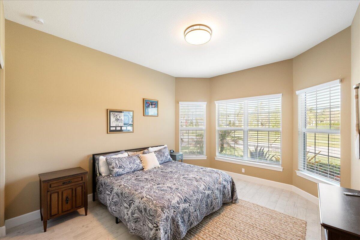 9941 Southwest Legacy Drive Stuart, FL 34997 - Photo 16 of 33 a bedroom with a bed and a large window