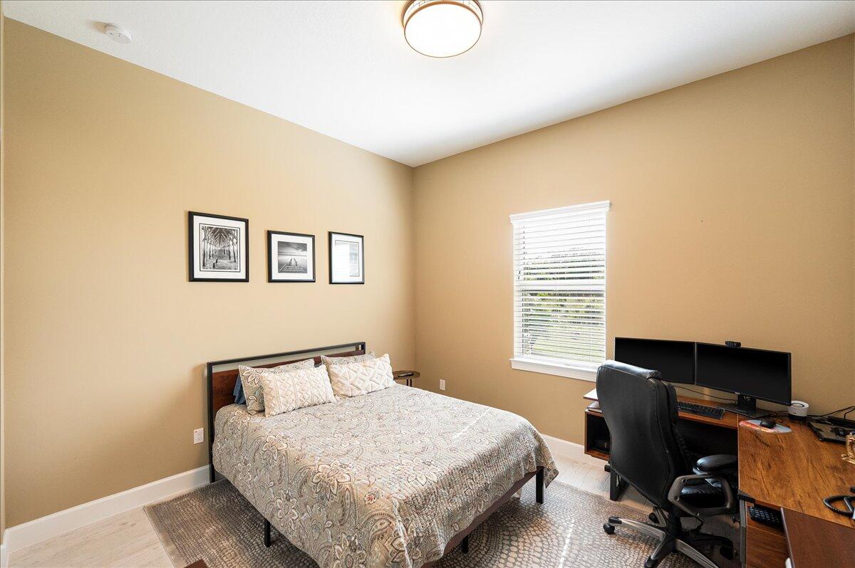 9941 Southwest Legacy Drive Stuart, FL 34997 - Photo 18 of 33 a bedroom with a bed and a desk