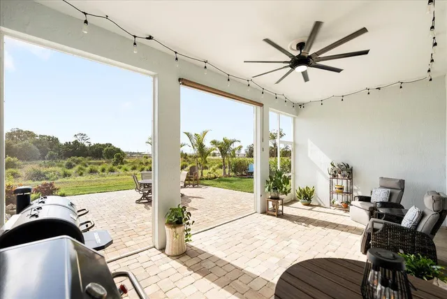 a living room with furniture a window and a chandelier