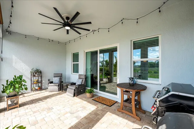 a view of a house with a backyard and a patio