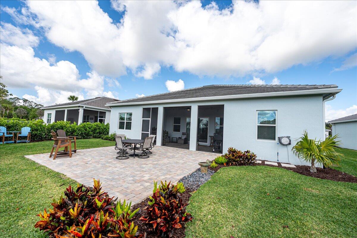 9941 Southwest Legacy Drive Stuart, FL 34997 - Photo 28 of 33 a view of a house with sitting area and garden