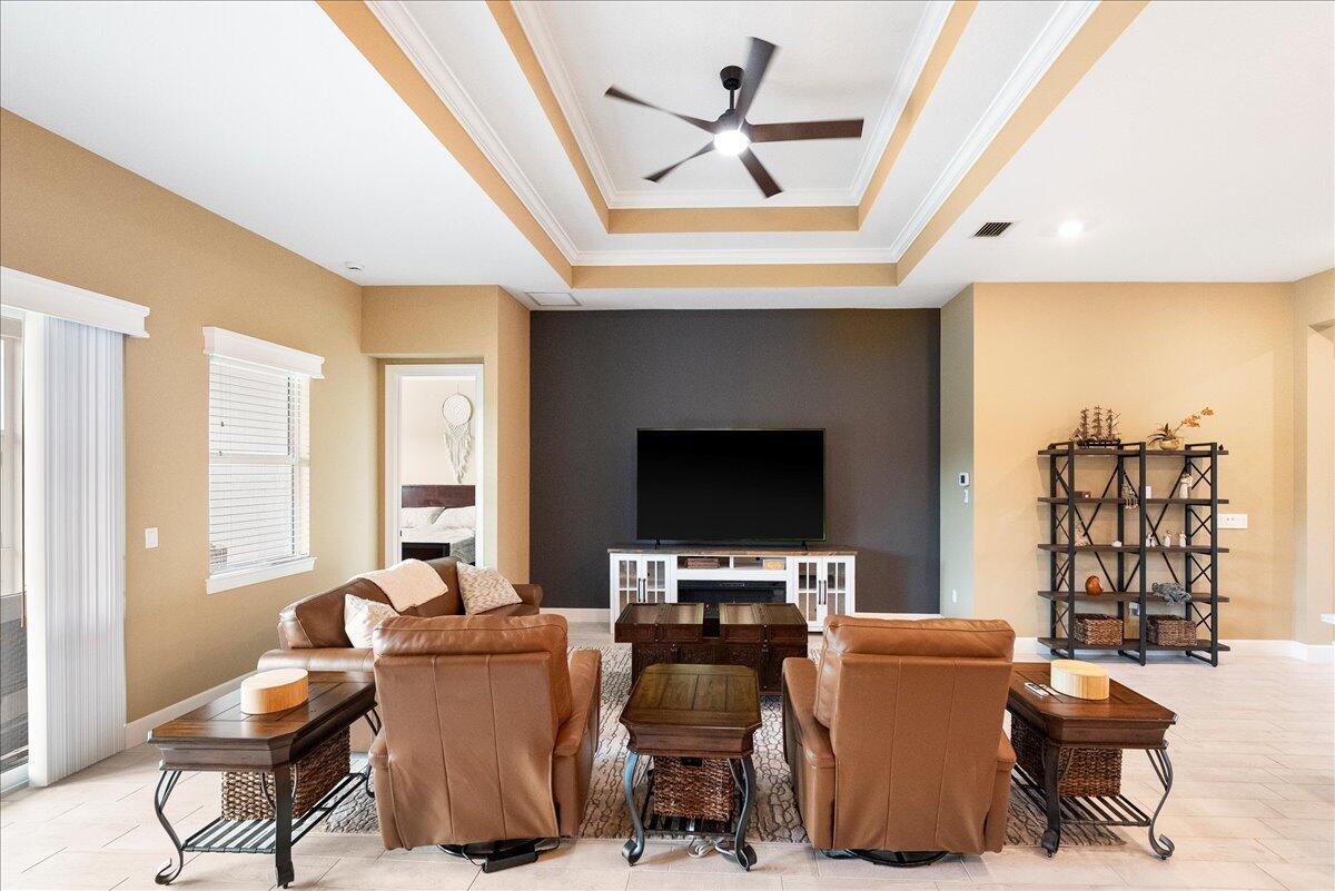 9941 Southwest Legacy Drive Stuart, FL 34997 - Photo 8 of 33 a living room with furniture a flat screen tv and a window