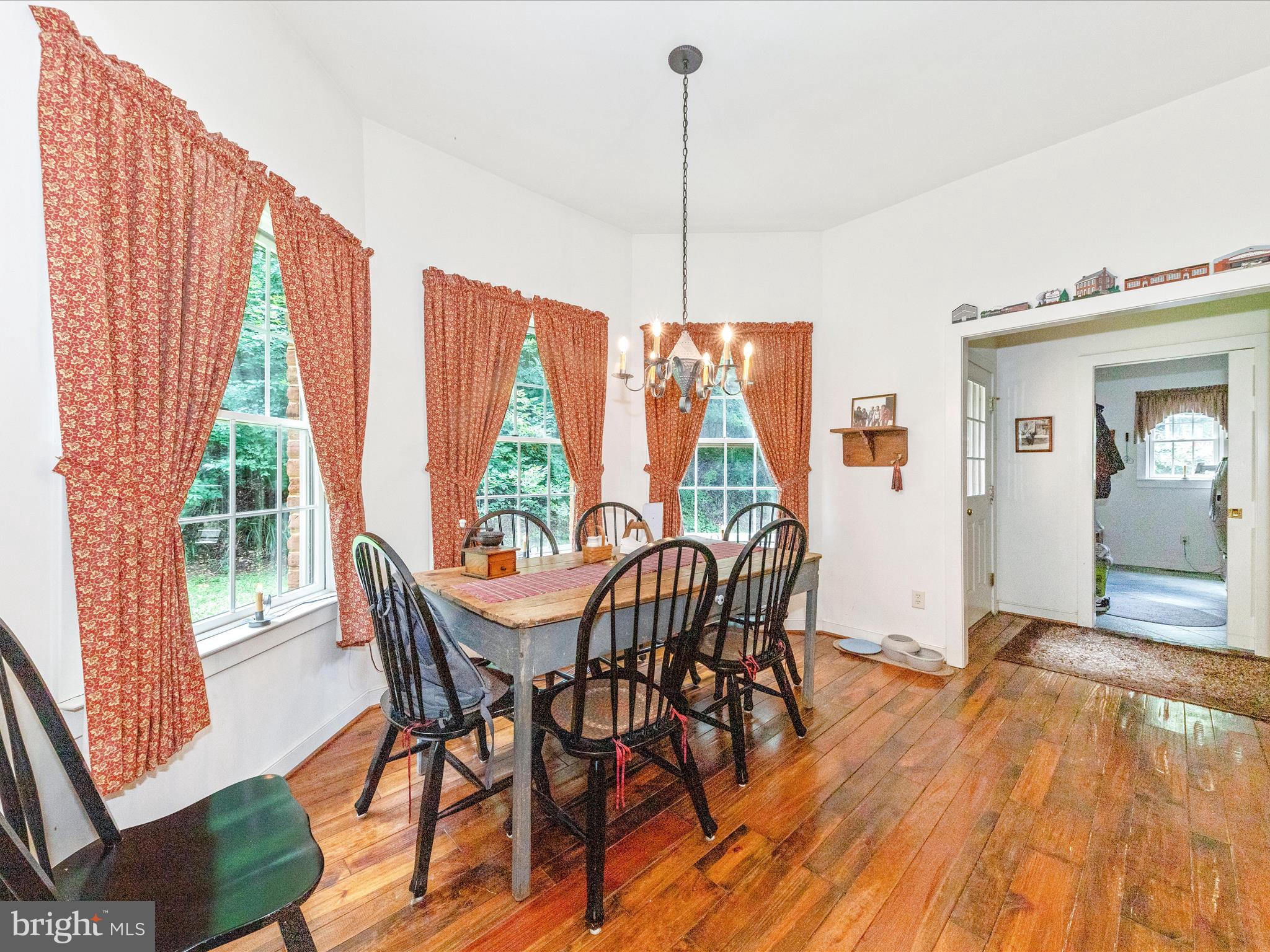 13013 Draper Road Clear Spring, MD 21722 - Photo 16 of 53 a view of a dining room with furniture wooden floor and a chandelier