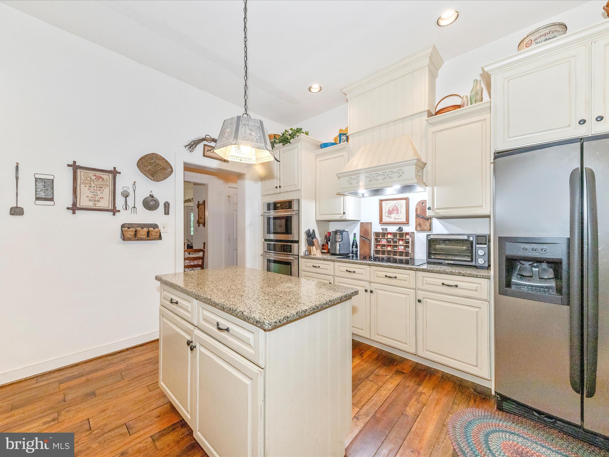 13013 Draper Road Clear Spring, MD 21722 - Photo 18 of 53 a kitchen with stainless steel appliances granite countertop a refrigerator a oven and a sink with wooden floor