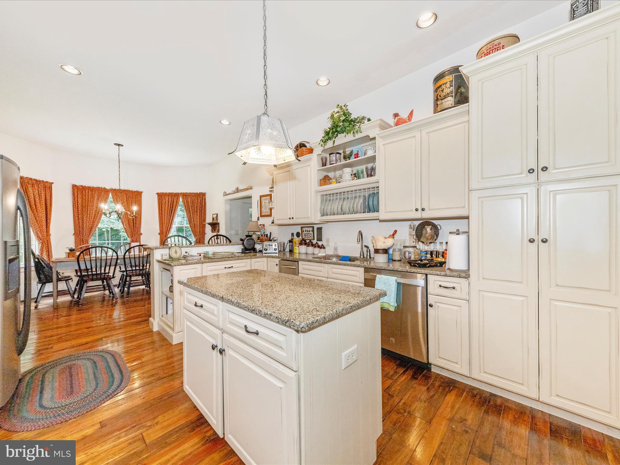 13013 Draper Road Clear Spring, MD 21722 - Photo 19 of 53 a kitchen with stainless steel appliances granite countertop a sink a stove and a wooden floors
