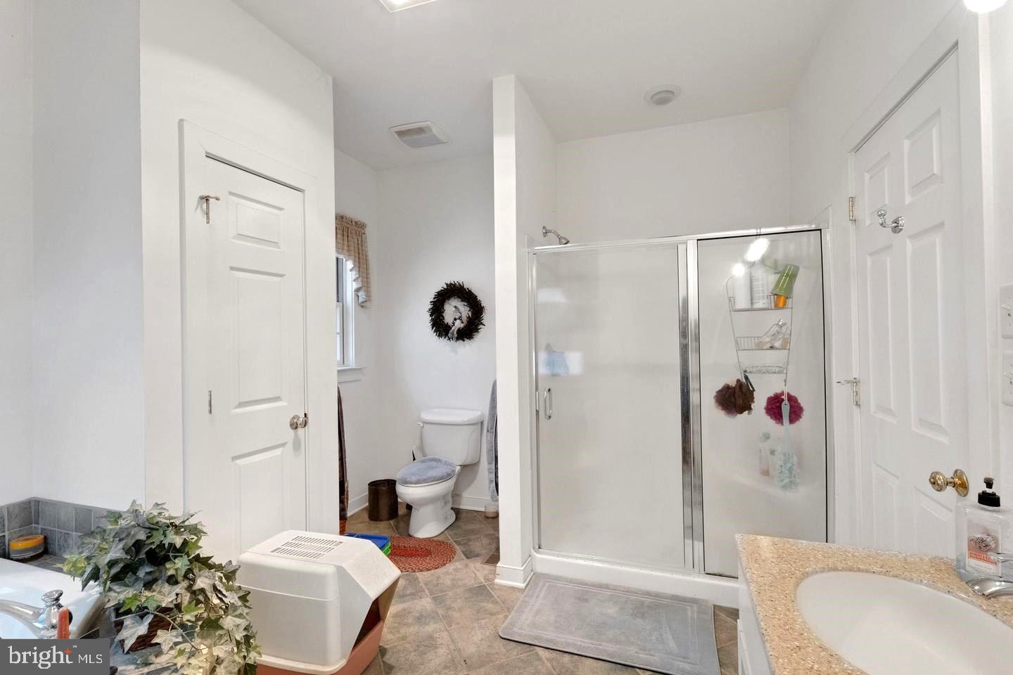 13013 Draper Road Clear Spring, MD 21722 - Photo 26 of 53 a spacious bathroom with a granite countertop sink toilet and shower