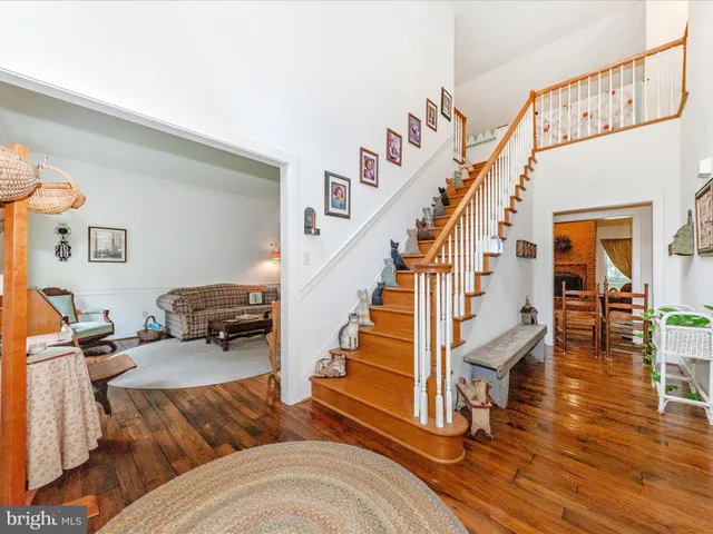 a bedroom with a bed a large window with table and chairs