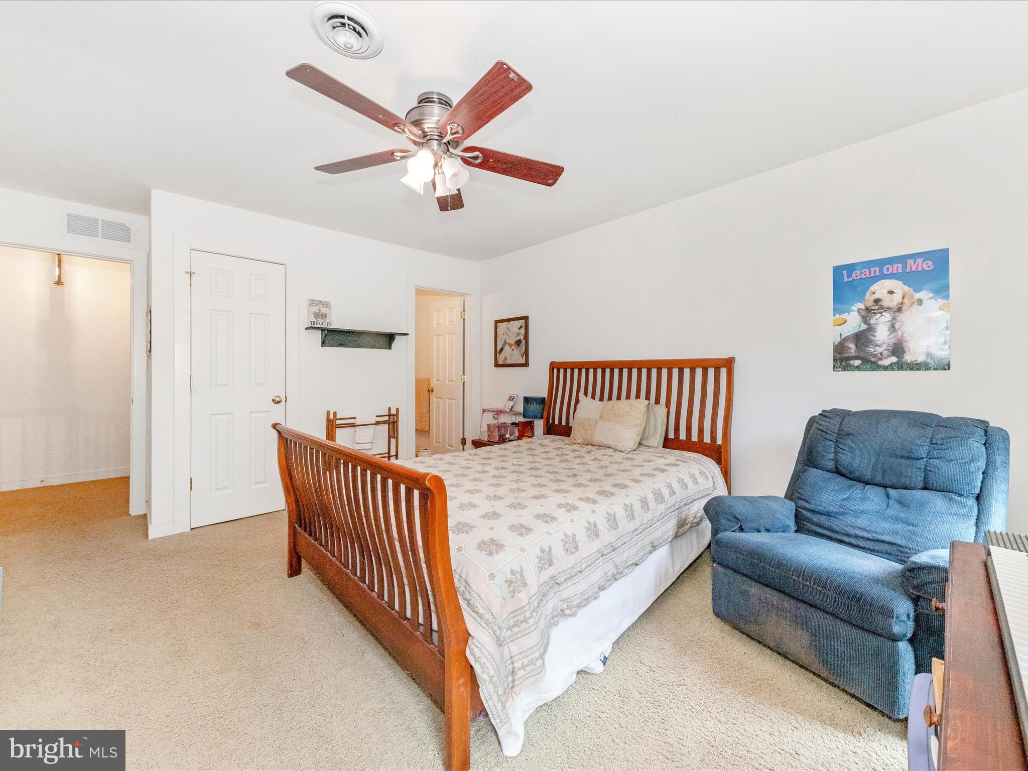 13013 Draper Road Clear Spring, MD 21722 - Photo 34 of 53 a spacious bedroom with a bed and a chandelier