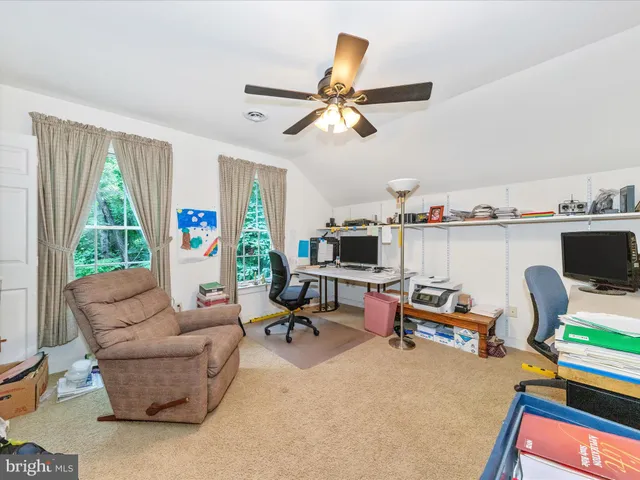 a living room with furniture and a bookshelf