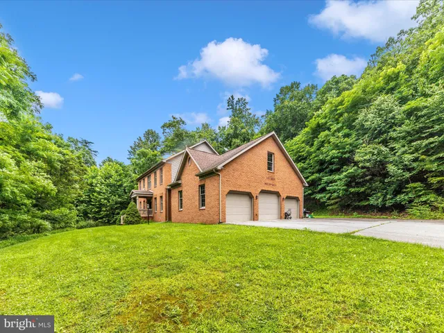 a view of a backyard with brick wall and furniture