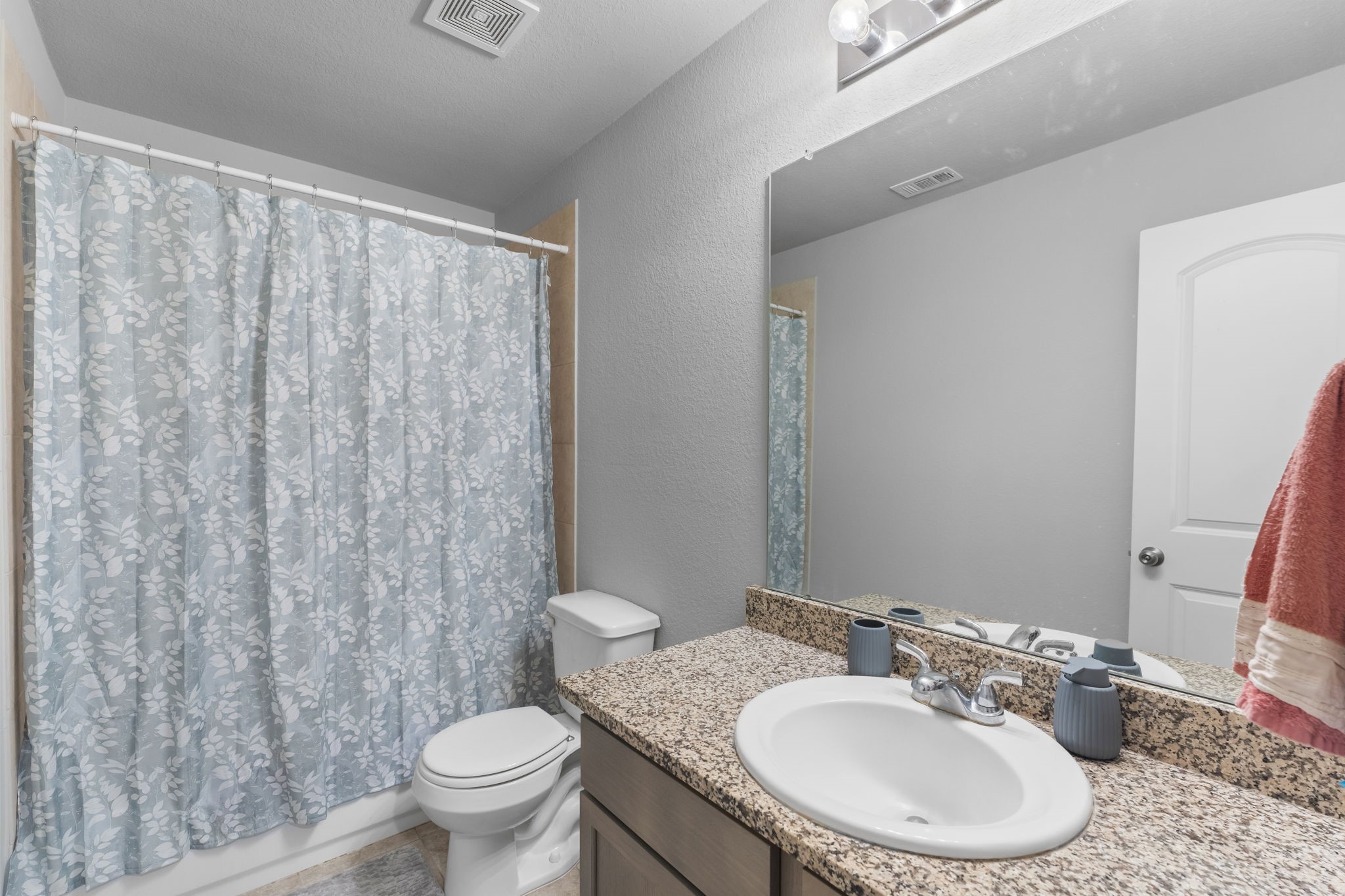 15120 Arrowhead Loop East Willis, TX 77378 - Photo 13 of 22 a bathroom with a toilet a sink and a mirror
