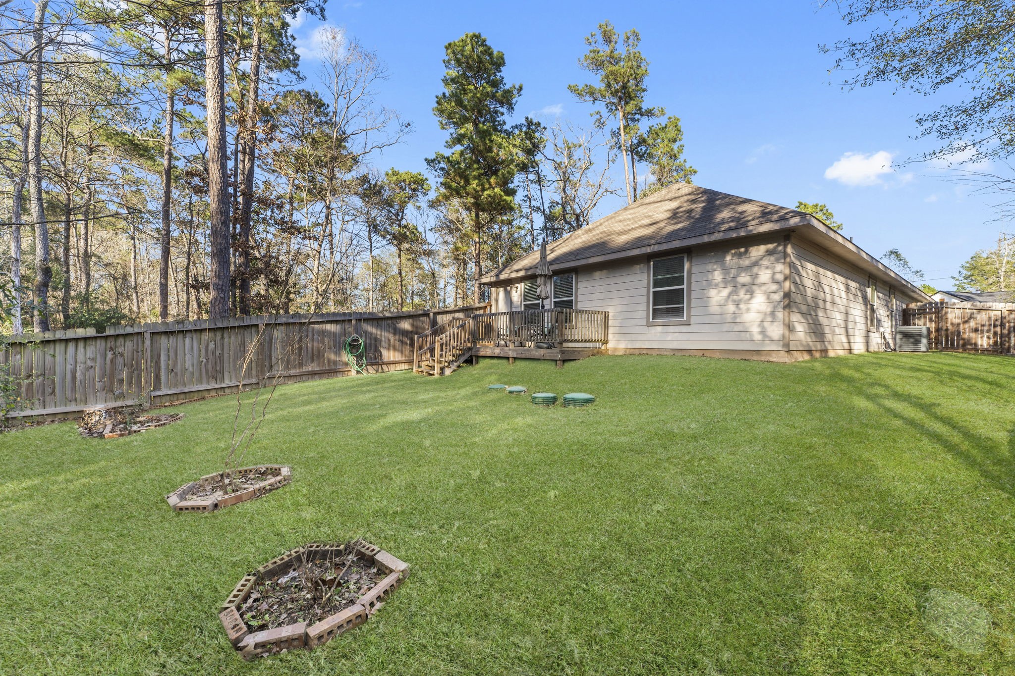 15120 Arrowhead Loop East Willis, TX 77378 - Photo 17 of 22 a view of a house with a yard and sitting area