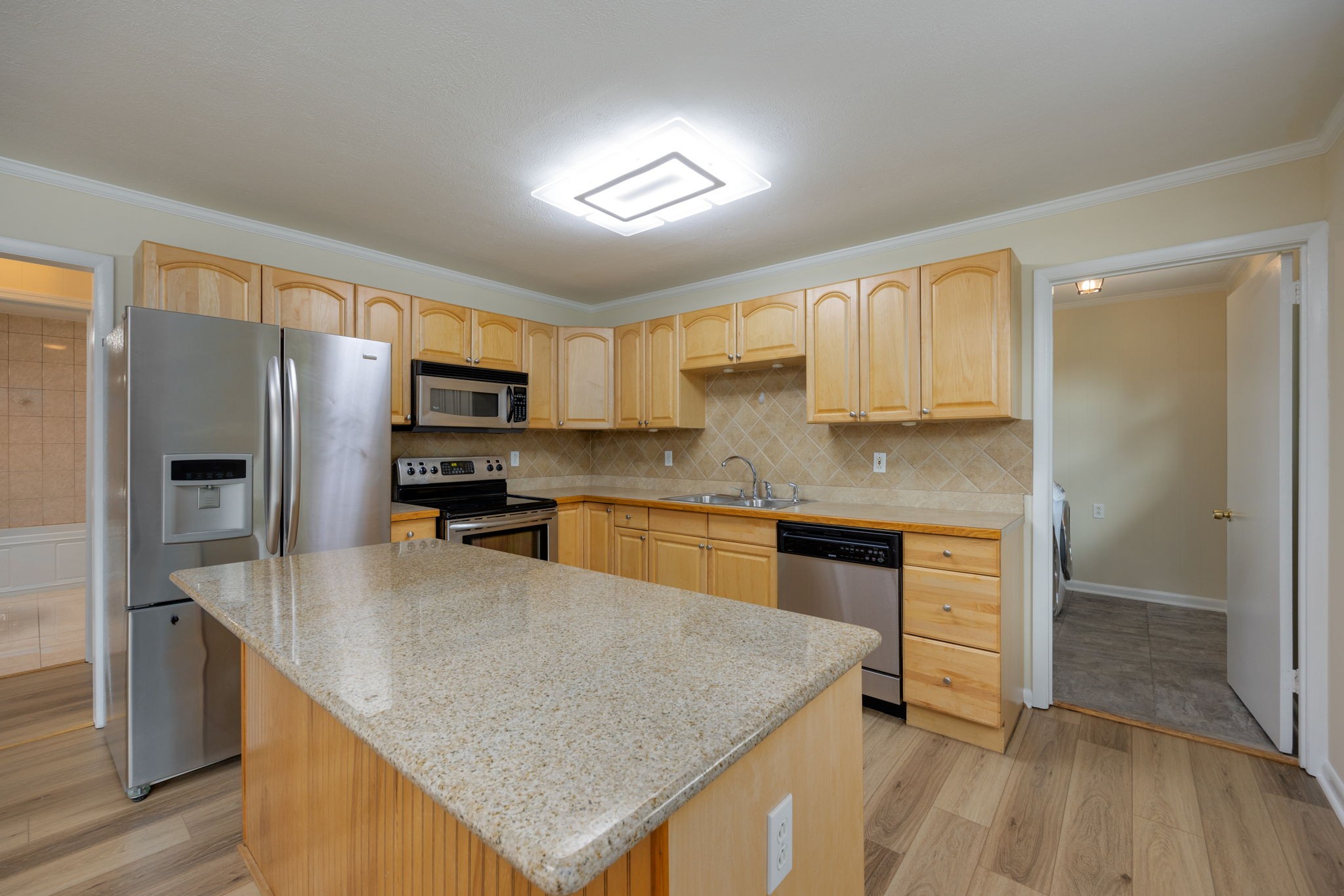 162 Searcy Road Mount Juliet, TN 37122 - Photo 17 of 46 a kitchen with stainless steel appliances granite countertop a refrigerator a sink a stove a microwave and island