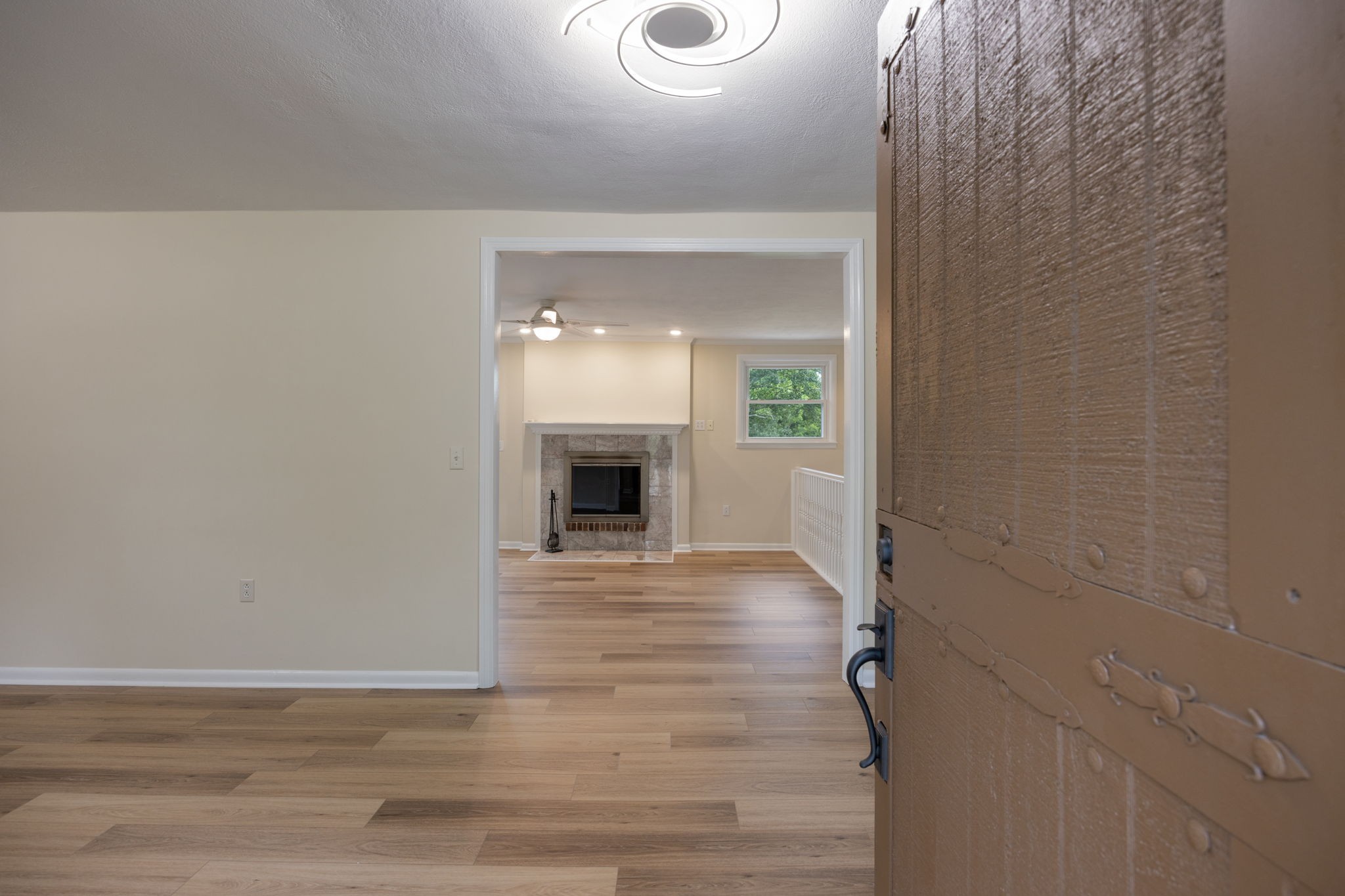162 Searcy Road Mount Juliet, TN 37122 - Photo 7 of 46 a view of empty room with wooden floor and fireplace