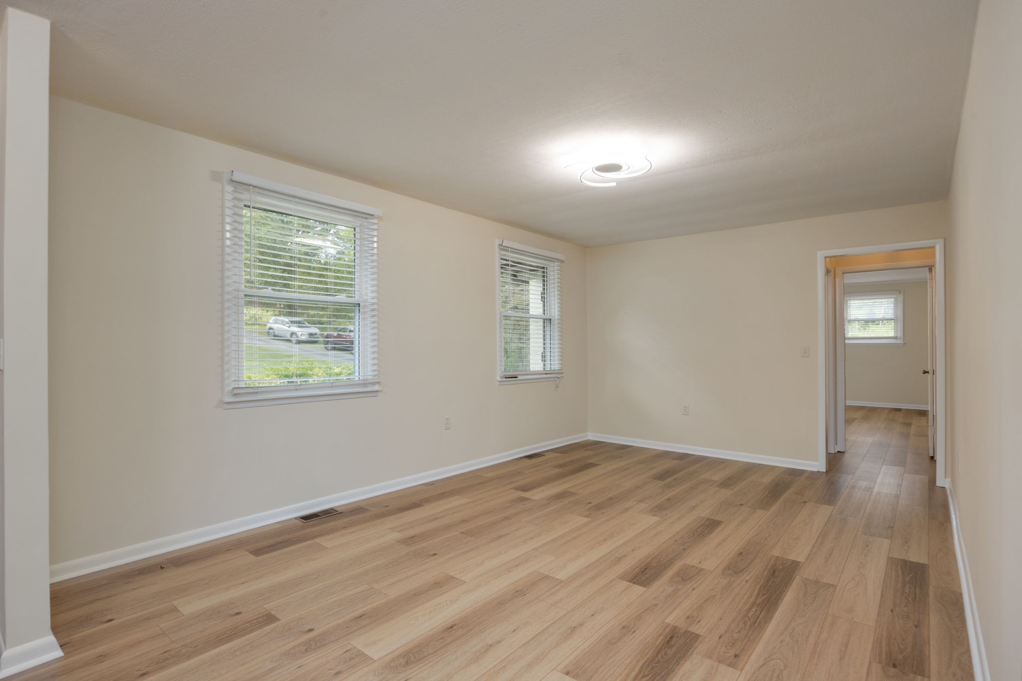 162 Searcy Road Mount Juliet, TN 37122 - Photo 8 of 46 an empty room with wooden floor and windows
