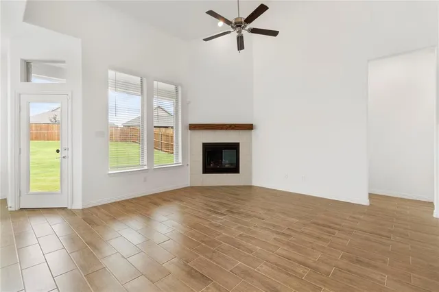 a view of an empty room with a window and a fireplace