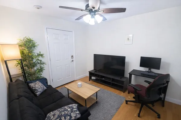 a living room with furniture and a flat screen tv