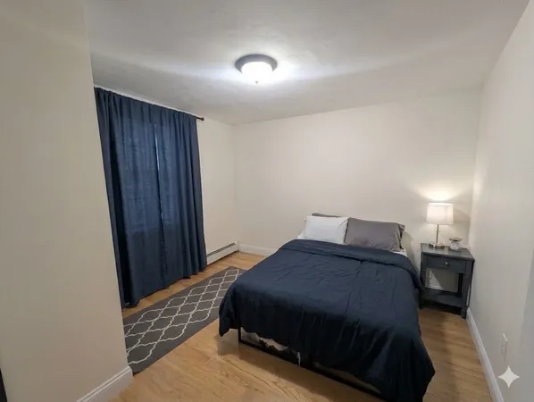 a bedroom with a bed and a table