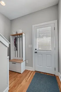 a view of a room with wooden floor and a window