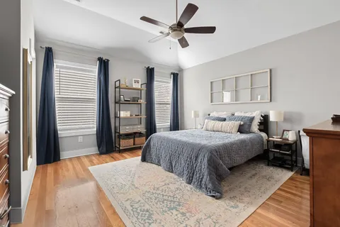 a bedroom with a bed and a large window