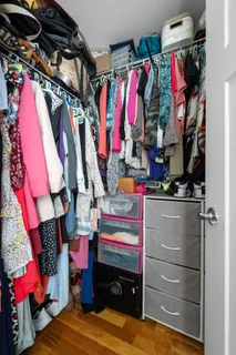 a view of walk in closet with clothes