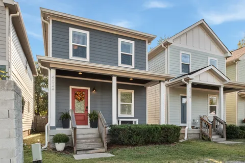 a view of a house with many windows and plants