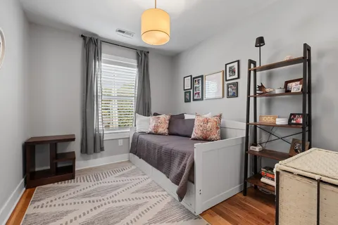a bedroom with a large bed and a chandelier
