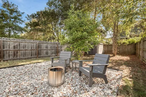 a view of a backyard with sitting area