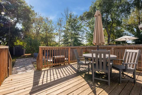 a view of balcony with wooden floor and outdoor seating