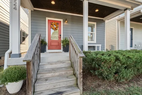 a front view of a house with a garden