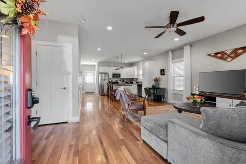 a living room with furniture and a chandelier