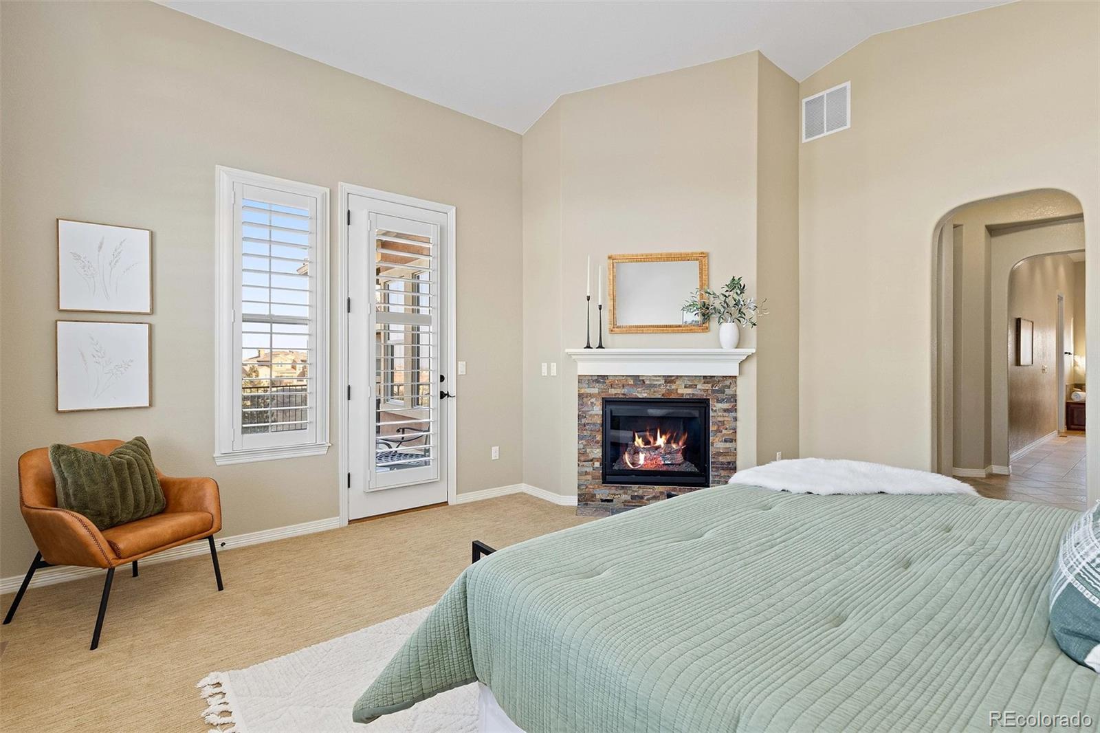 9581 Firenze Way Highlands Ranch, CO 80126 - Photo 18 of 48 a bedroom with a bed and a chair