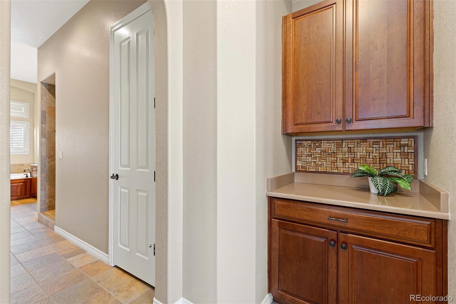 9581 Firenze Way Highlands Ranch, CO 80126 - Photo 19 of 48 a view of a kitchen with granite countertop white cabinets and a sink