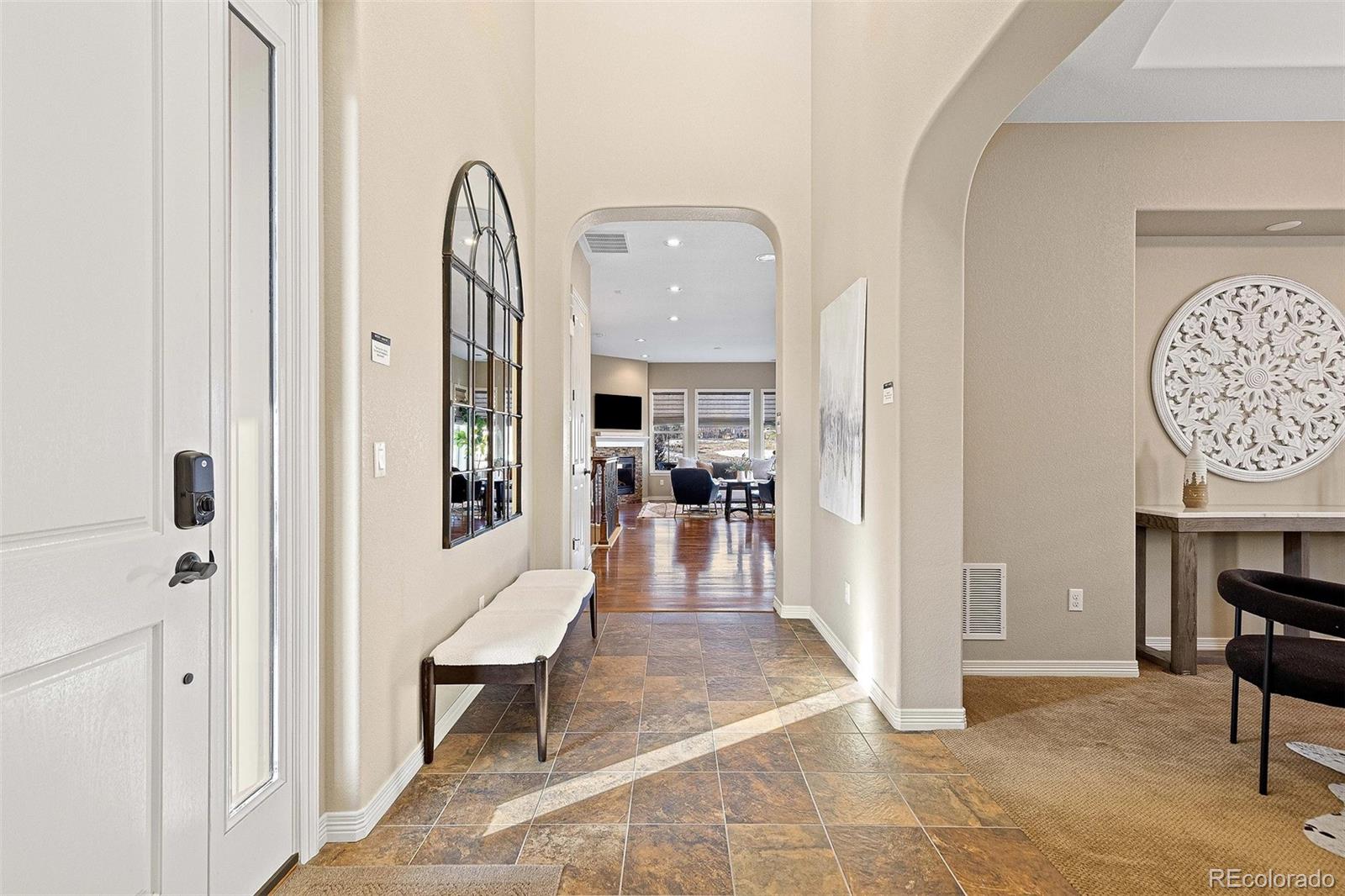 9581 Firenze Way Highlands Ranch, CO 80126 - Photo 3 of 48 a view of living room filled with furniture and wooden floor