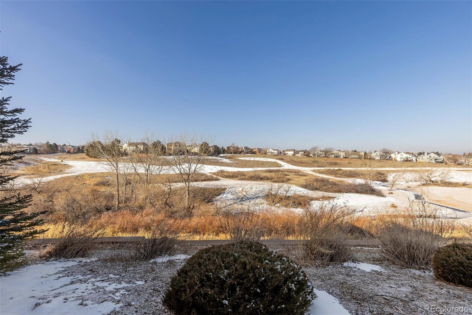 9581 Firenze Way Highlands Ranch, CO 80126 - Photo 40 of 48 a view of a lake with a beach
