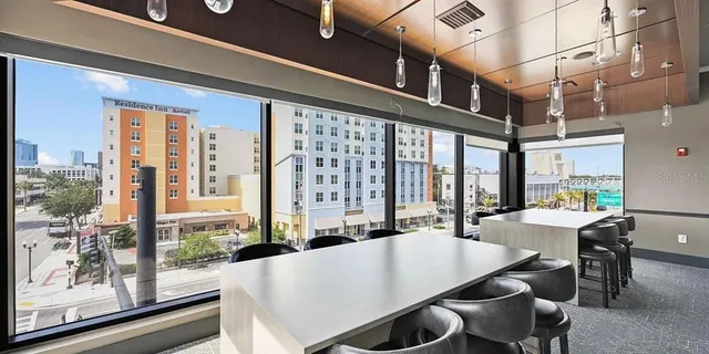 a view of a dining room with furniture and a window