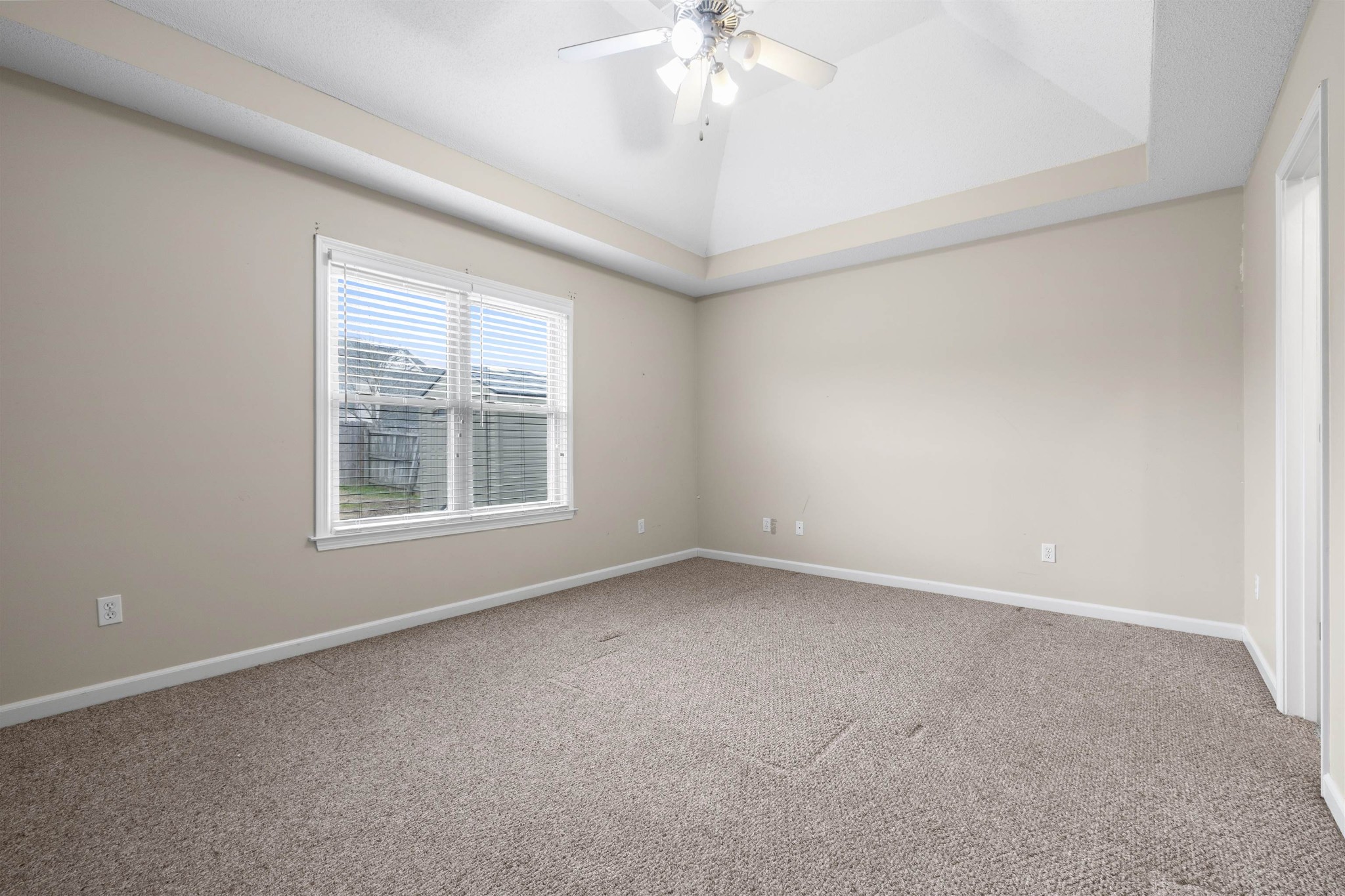 220 Terry Road Somerville, TN 38068 - Photo 15 of 29 an empty room with a chandelier fan and windows