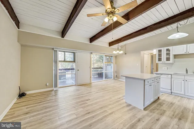 a large kitchen with stainless steel appliances granite countertop a refrigerator and a stove top oven