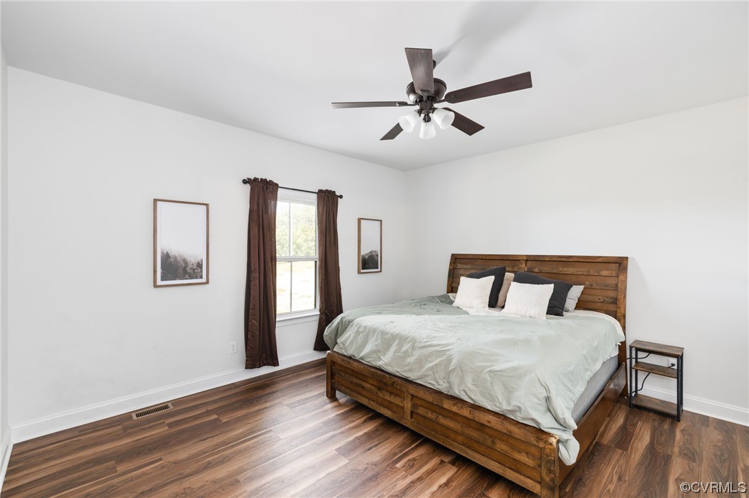 922 Kennon Road Mineral, VA 23117 - Photo 20 of 36 a bedroom with a large bed and a chandelier