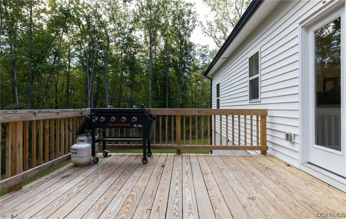 922 Kennon Road Mineral, VA 23117 - Photo 34 of 36 a view of a wooden deck with a bench