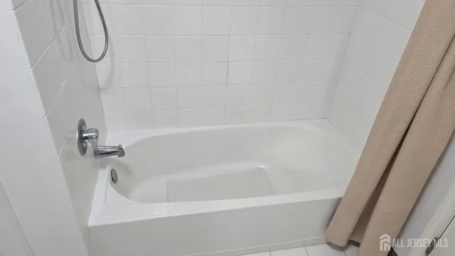 a kitchen with stainless steel appliances granite countertop a stove a refrigerator a sink a dining table and chairs