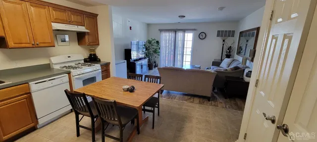 a living room with furniture dining room and wooden floor