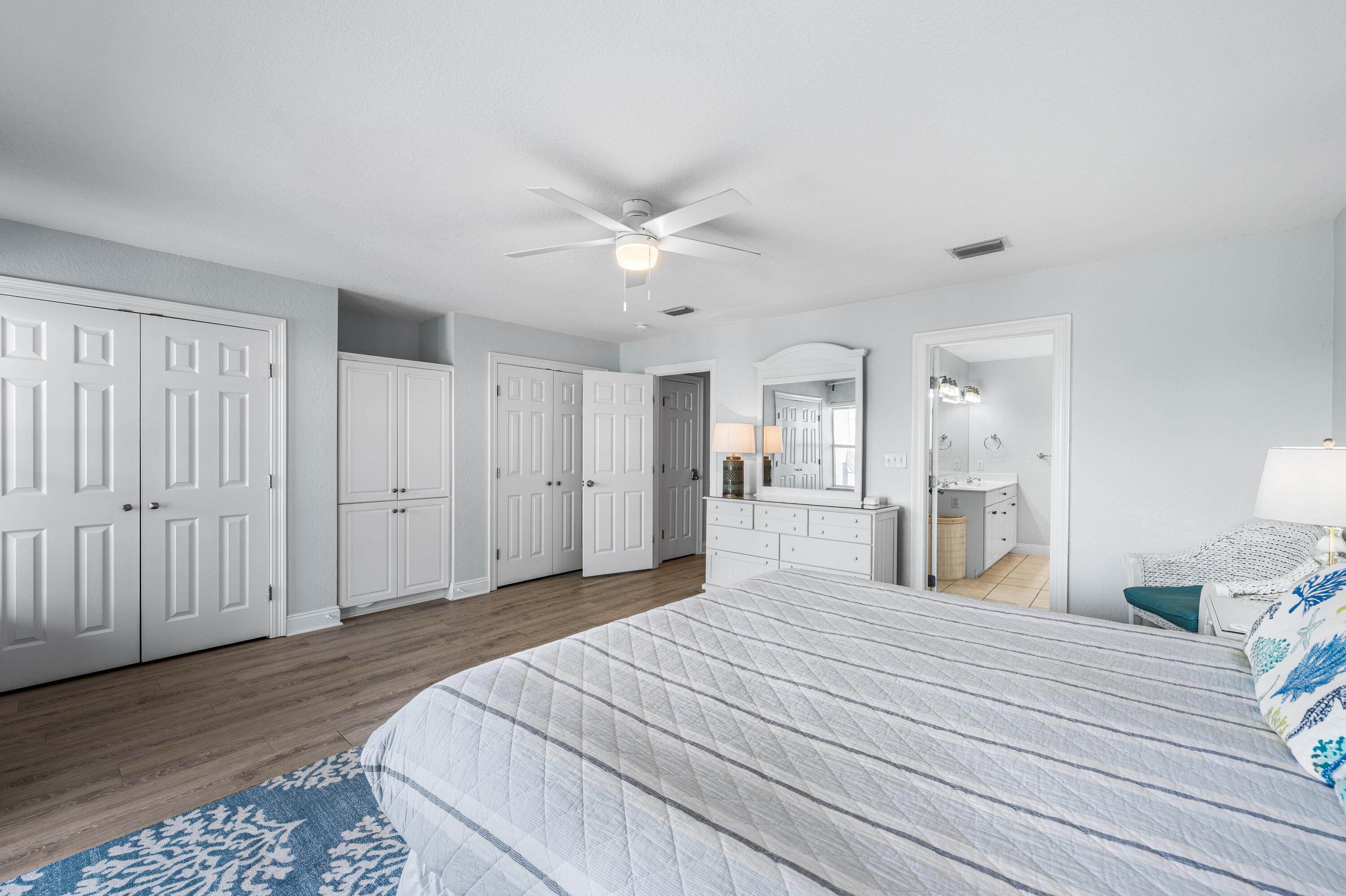 33 Dune Breeze Lane, Unit H2 Santa Rosa Beach, FL 32459 - Photo 18 of 54 a spacious bedroom with a bed and a chandelier